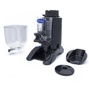 Moulin à café Maxima pour grains de 2 kg avec doseur, visible avec ses composants en acier et mécanisme de broyage.